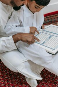 man teaching quran